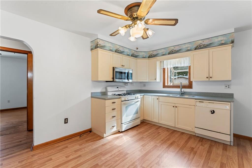 122 Georgetown Road Beaver Falls, PA 15010 - Photo 21 of 44 a kitchen with stainless steel appliances granite countertop a stove cabinets and wooden floor