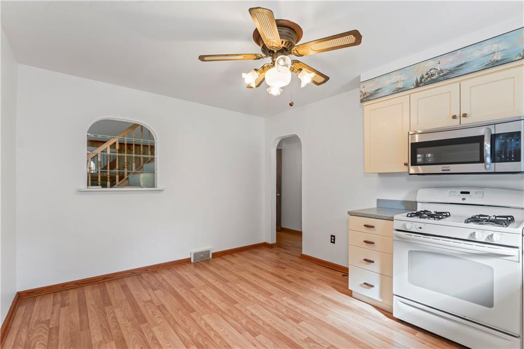 122 Georgetown Road Beaver Falls, PA 15010 - Photo 22 of 44 a kitchen with stainless steel appliances granite countertop a stove a sink dishwasher and a microwave oven with cabinets
