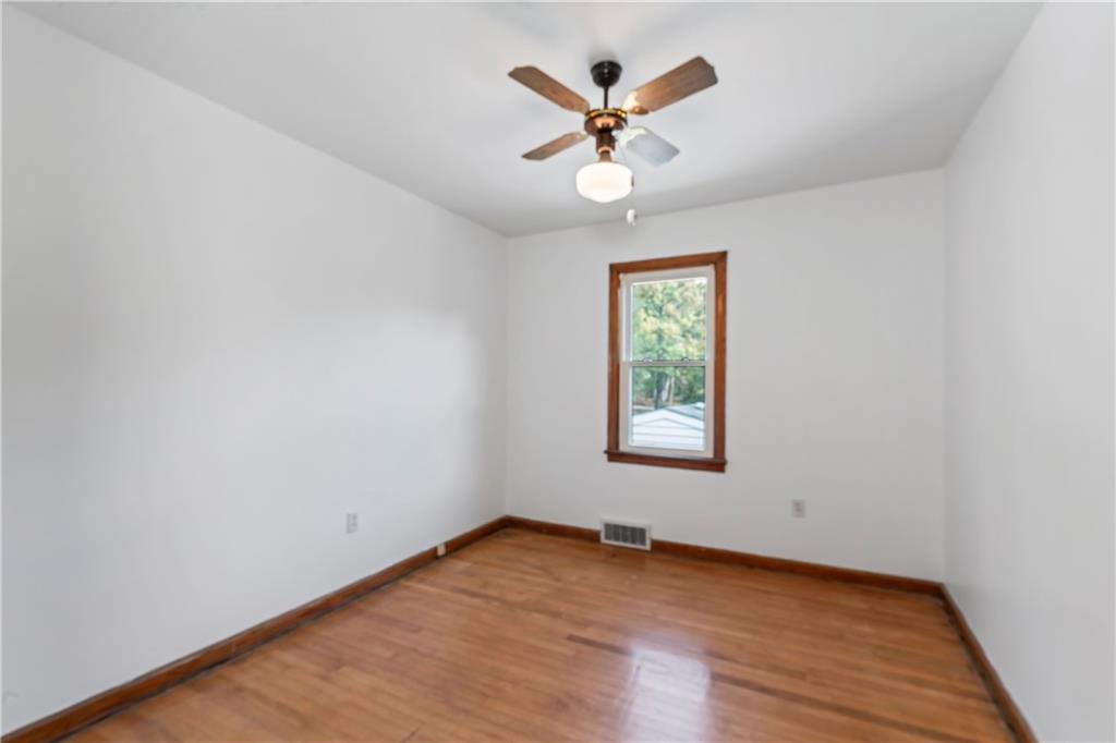 122 Georgetown Road Beaver Falls, PA 15010 - Photo 26 of 44 an empty room with wooden floor and windows