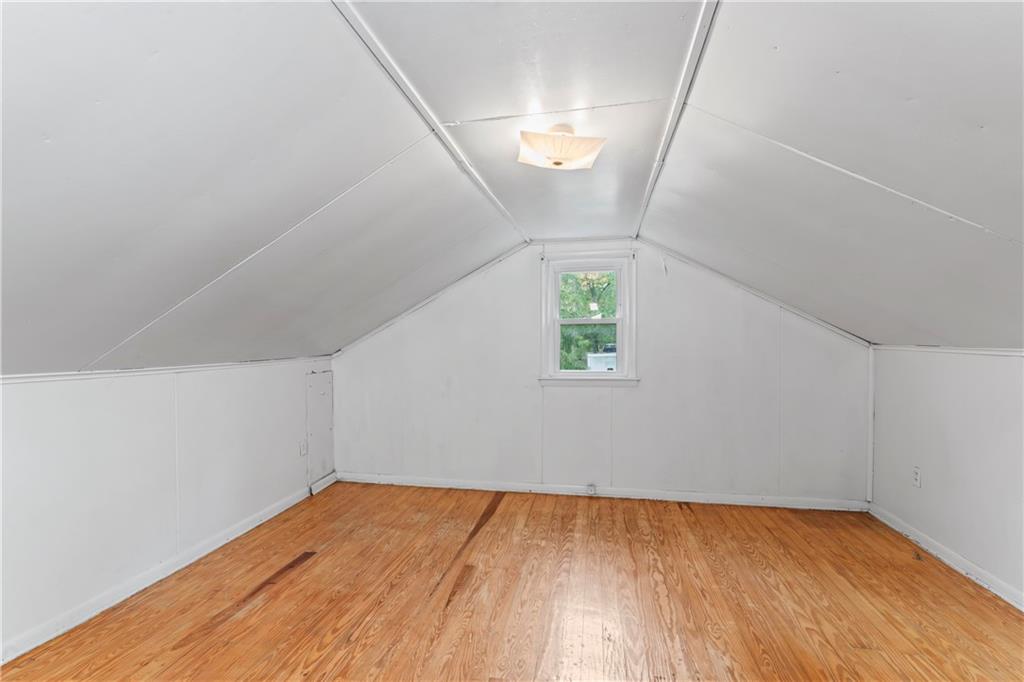 122 Georgetown Road Beaver Falls, PA 15010 - Photo 30 of 44 an empty room with wooden floor and windows