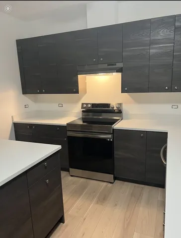 a kitchen with a sink and a stove top oven