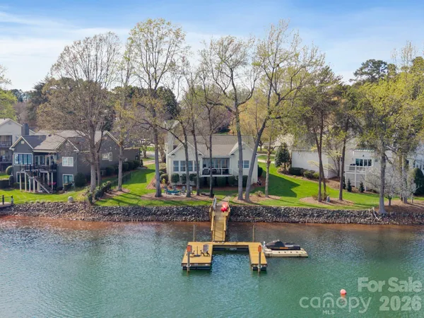 a view of pool with umbrella and trees