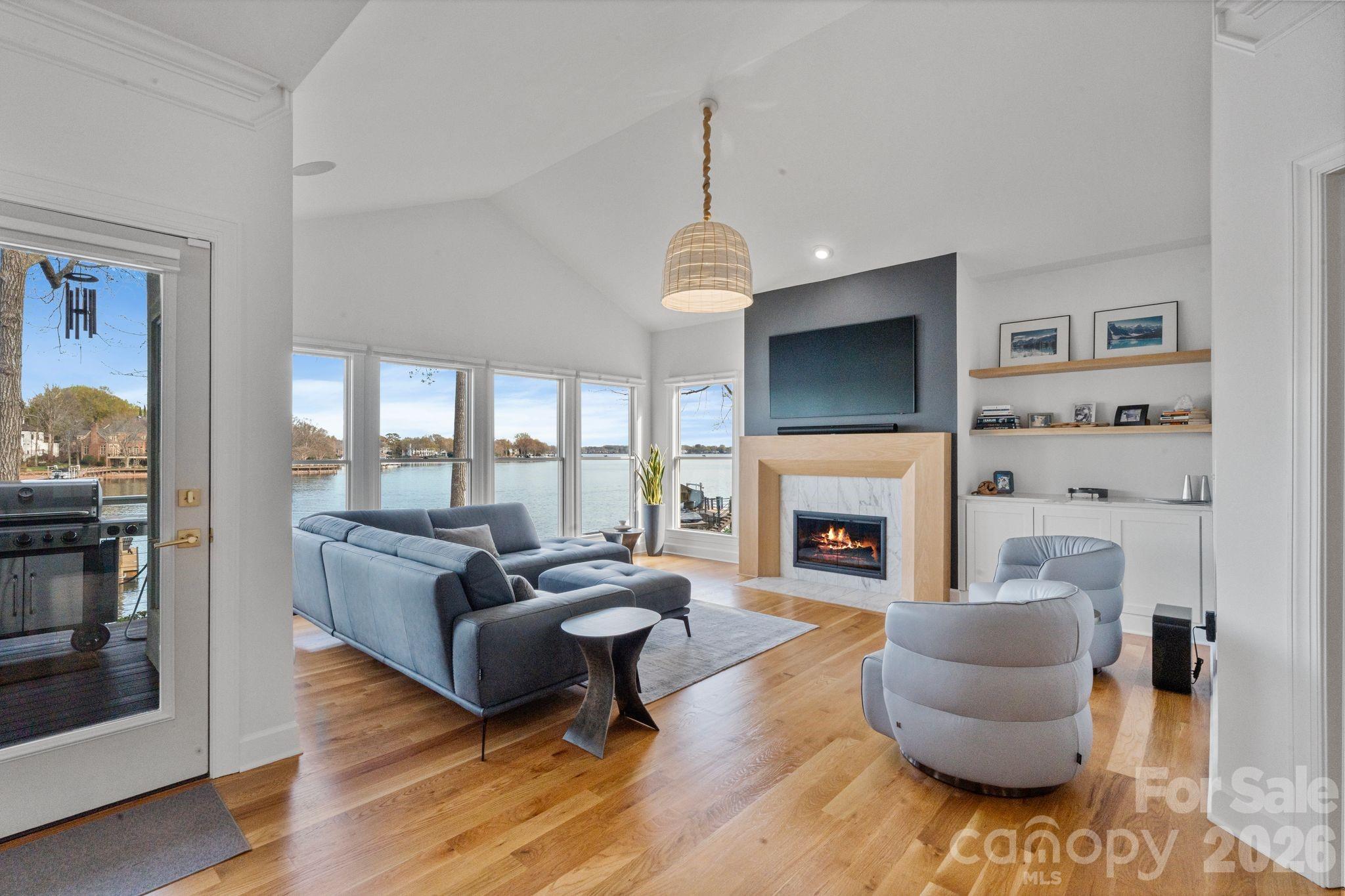 17723 Springwinds Drive Cornelius, NC 28031 - Photo 11 of 34 a living room with furniture a flat screen tv and a fireplace