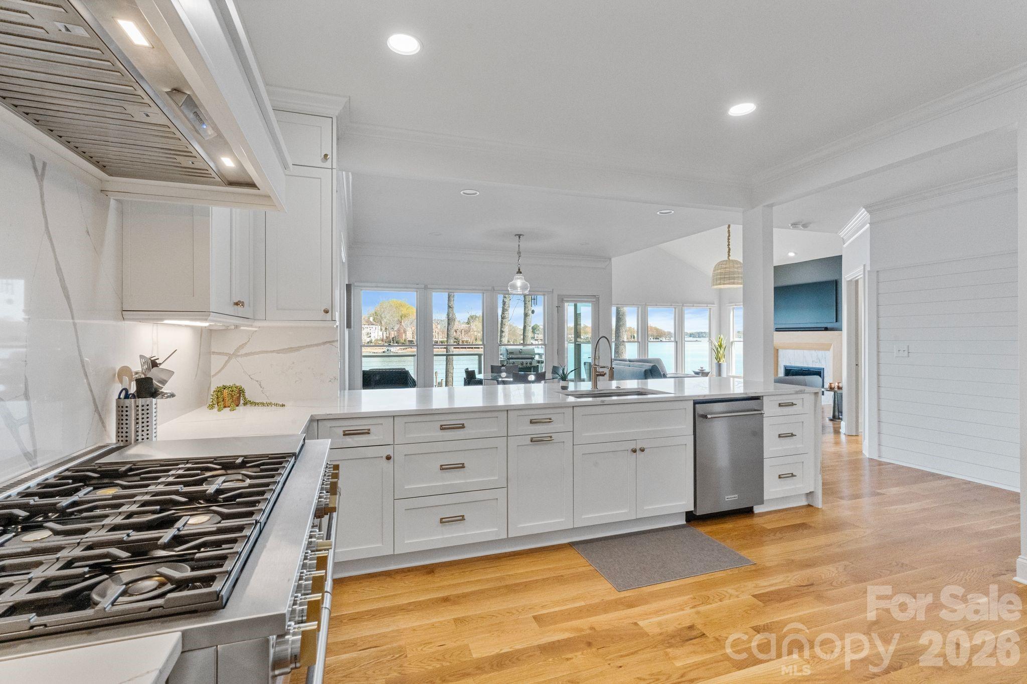 17723 Springwinds Drive Cornelius, NC 28031 - Photo 14 of 34 a kitchen with white cabinets and appliances