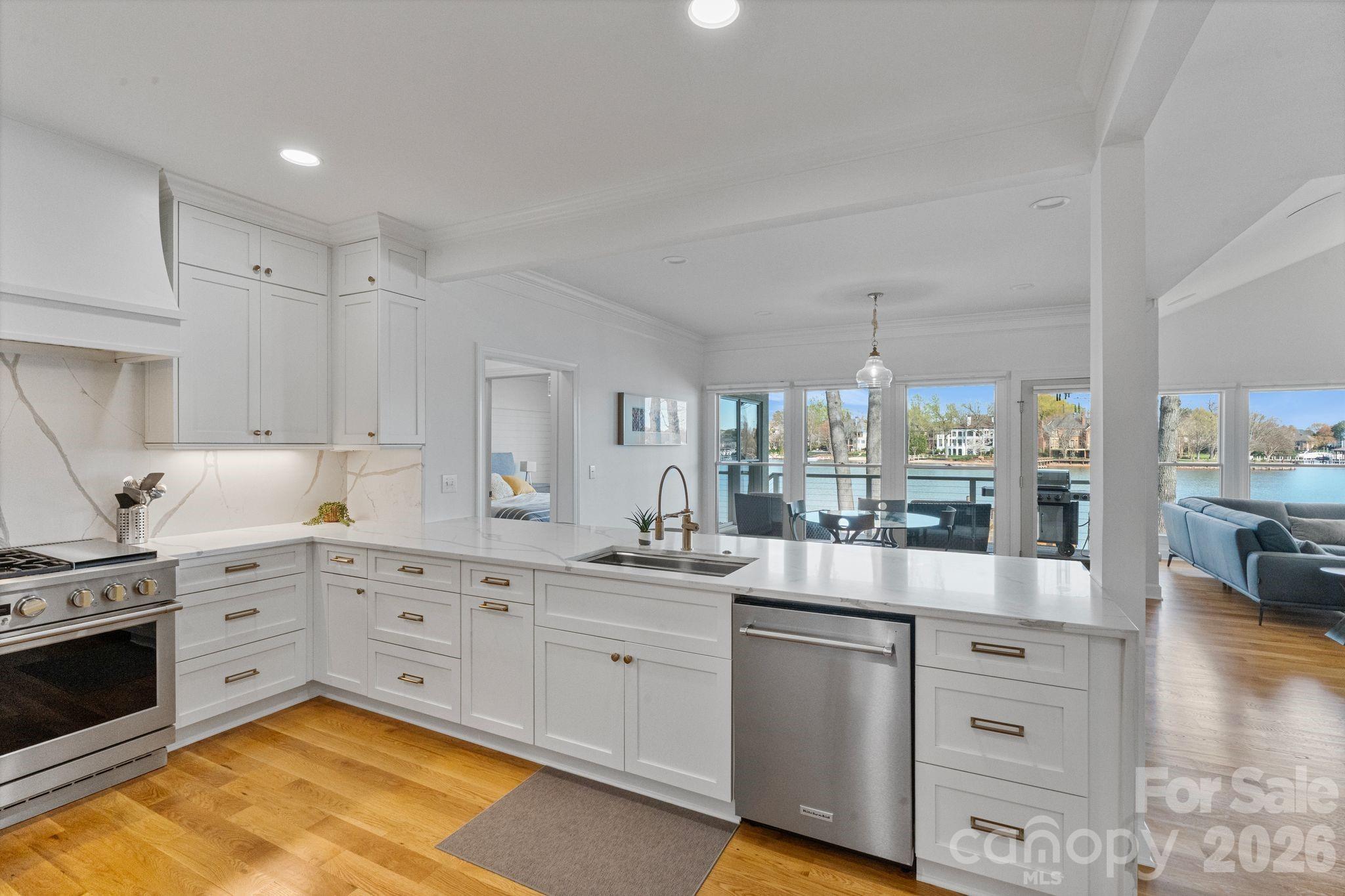 17723 Springwinds Drive Cornelius, NC 28031 - Photo 16 of 34 a kitchen with white cabinets and white appliances