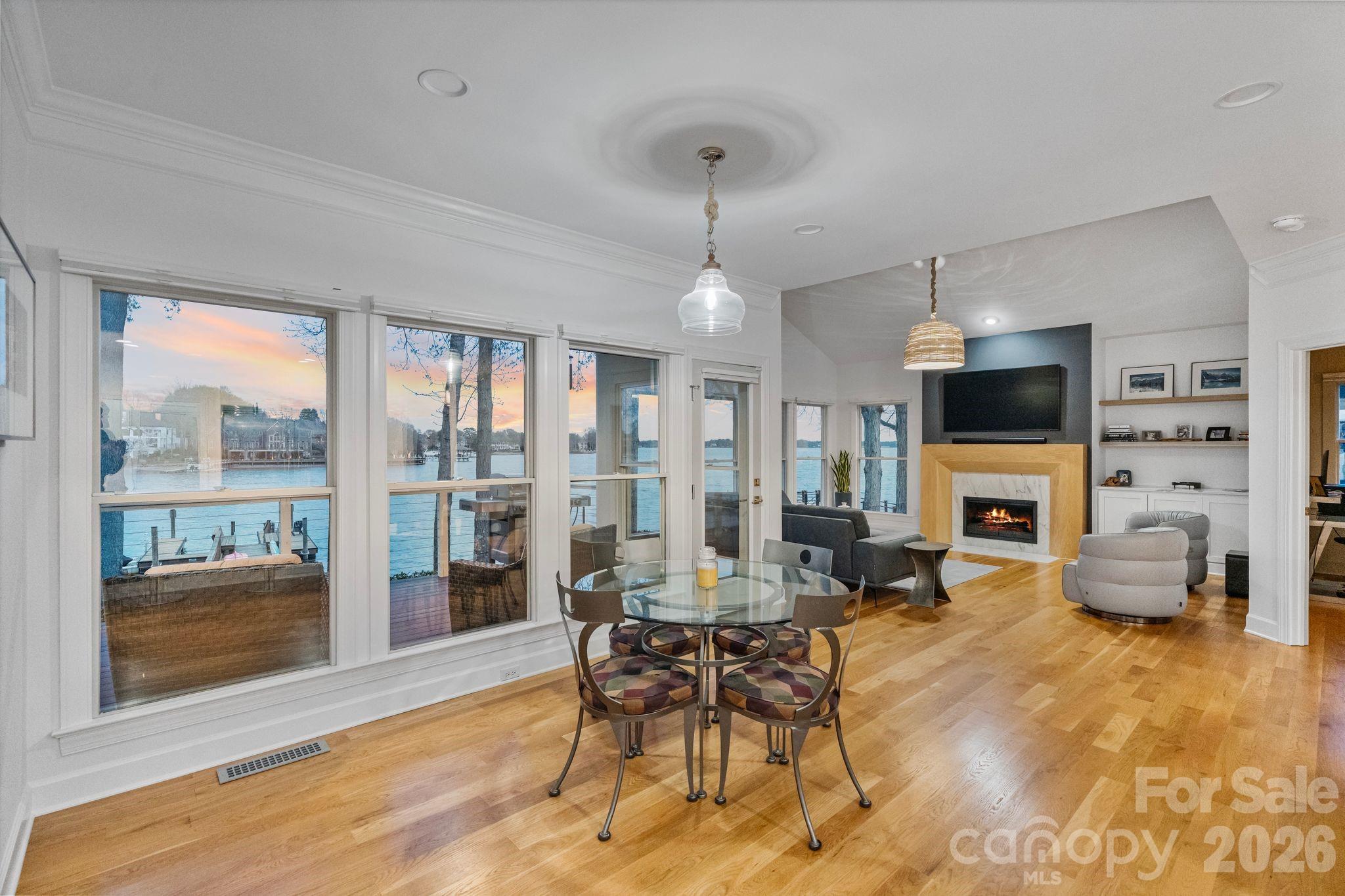 17723 Springwinds Drive Cornelius, NC 28031 - Photo 19 of 34 a living room with furniture a fireplace and a flat screen tv