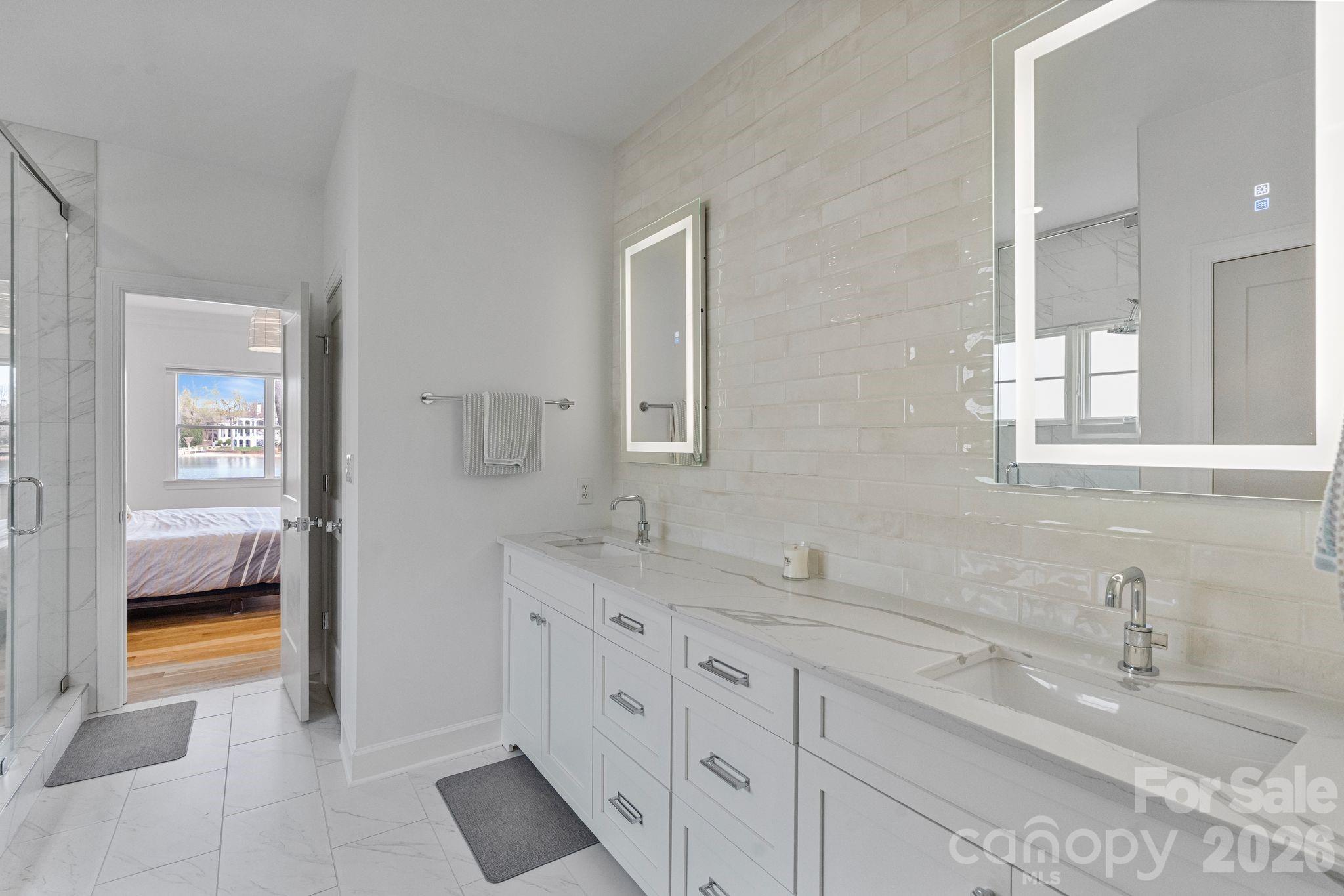 17723 Springwinds Drive Cornelius, NC 28031 - Photo 23 of 34 a en suite bathroom with double sink and a mirror