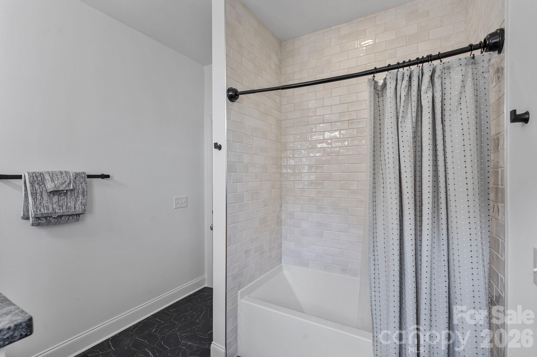 17723 Springwinds Drive Cornelius, NC 28031 - Photo 27 of 34 a bathroom with a shower and a bath tub