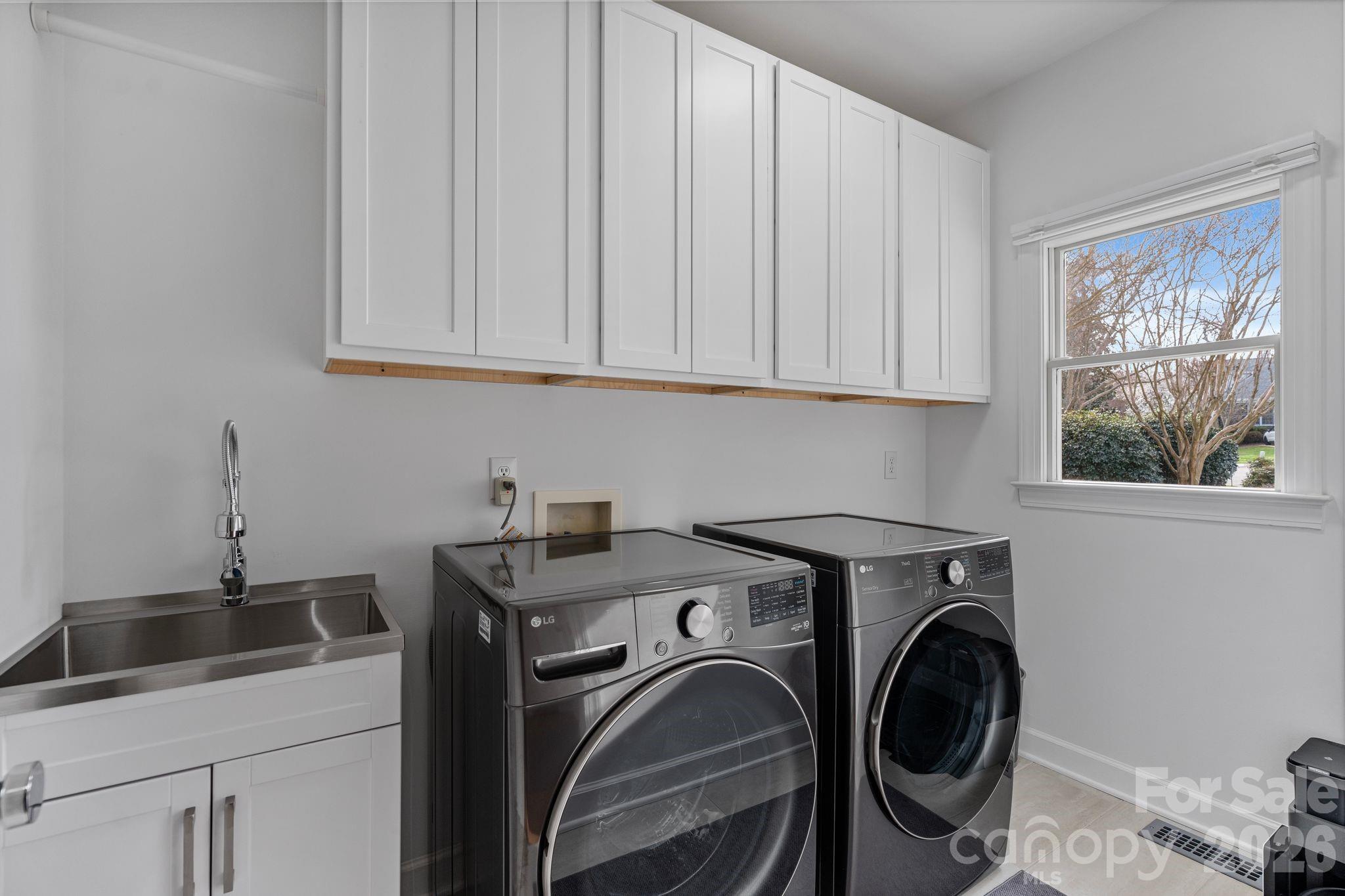 17723 Springwinds Drive Cornelius, NC 28031 - Photo 32 of 34 a utility room with sink dryer and washer