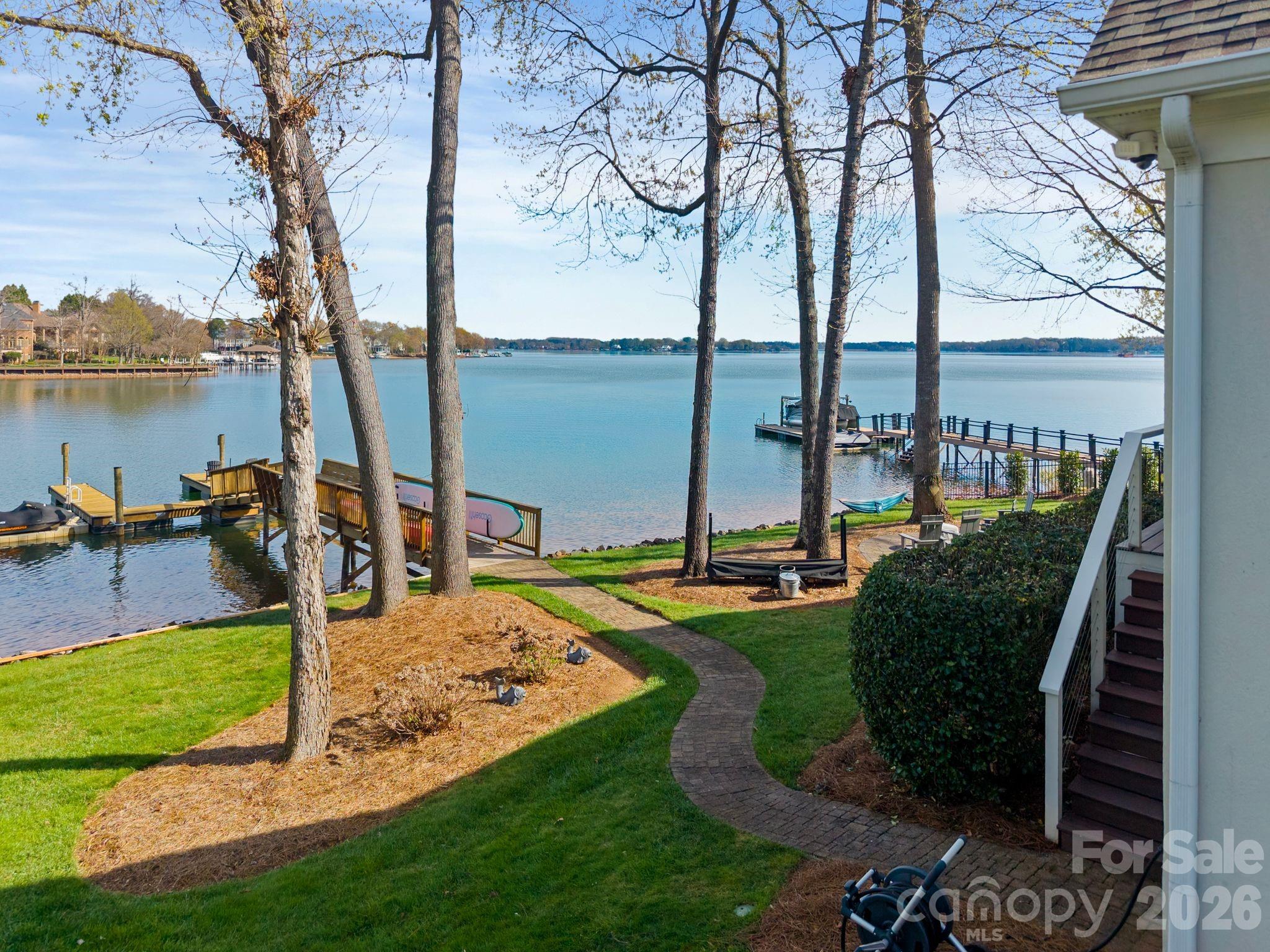 17723 Springwinds Drive Cornelius, NC 28031 - Photo 8 of 34 a view of a swimming pool with a garden and lawn chairs