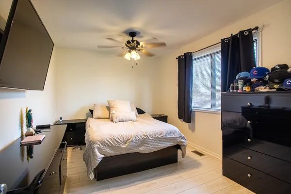 a bedroom with a bed and flat screen tv