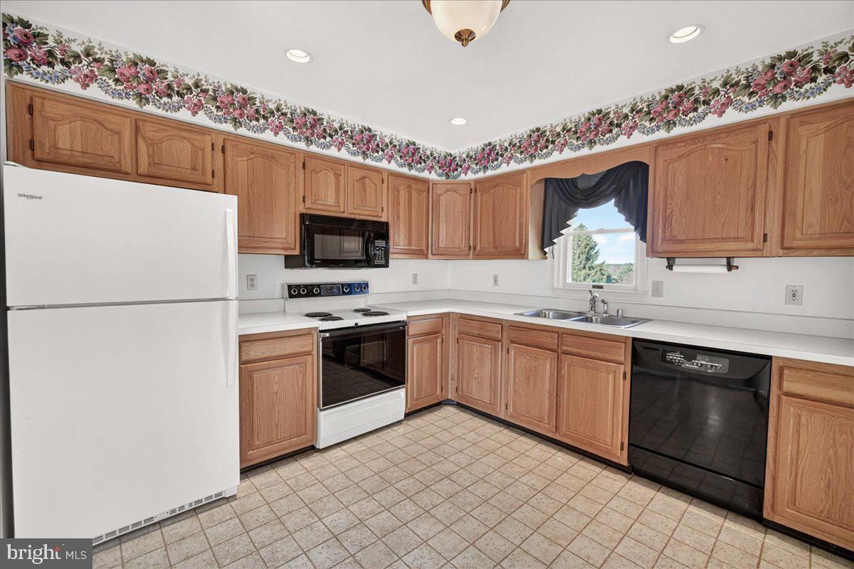 4715 Green Valley Road Monrovia, MD 21770 - Photo 14 of 36 a kitchen with granite countertop a sink stainless steel appliances and cabinets