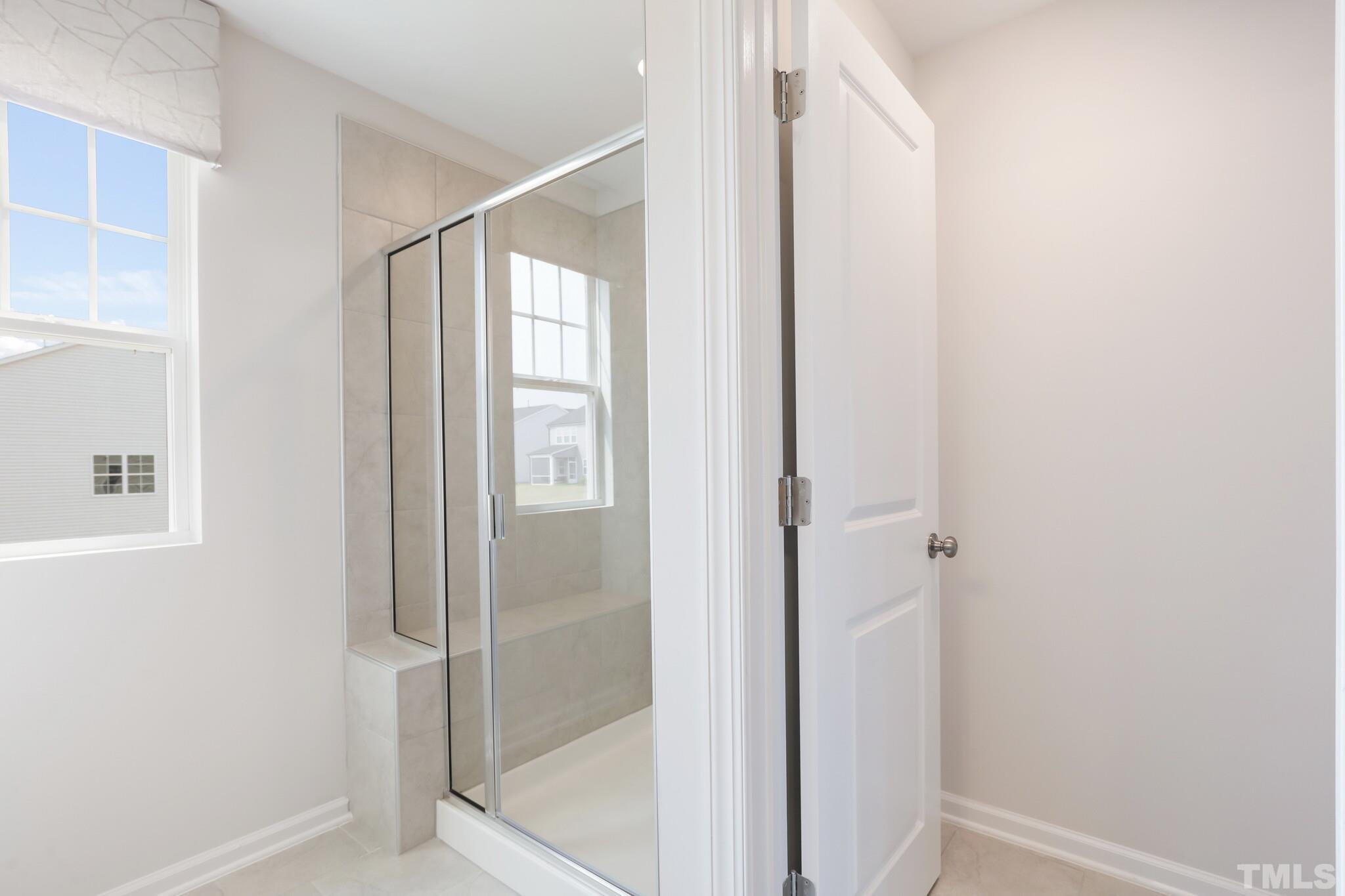4041 Mount Moran Road Raleigh, NC 27616 - Photo 17 of 24 a bathroom with a glass shower door