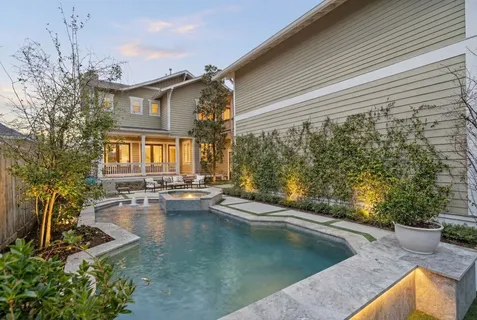a view of a house with pool and sitting area