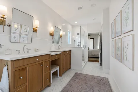 a spacious bathroom with a double vanity sink mirror and double