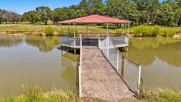 a view of a lake with wooden floor and outdoor space