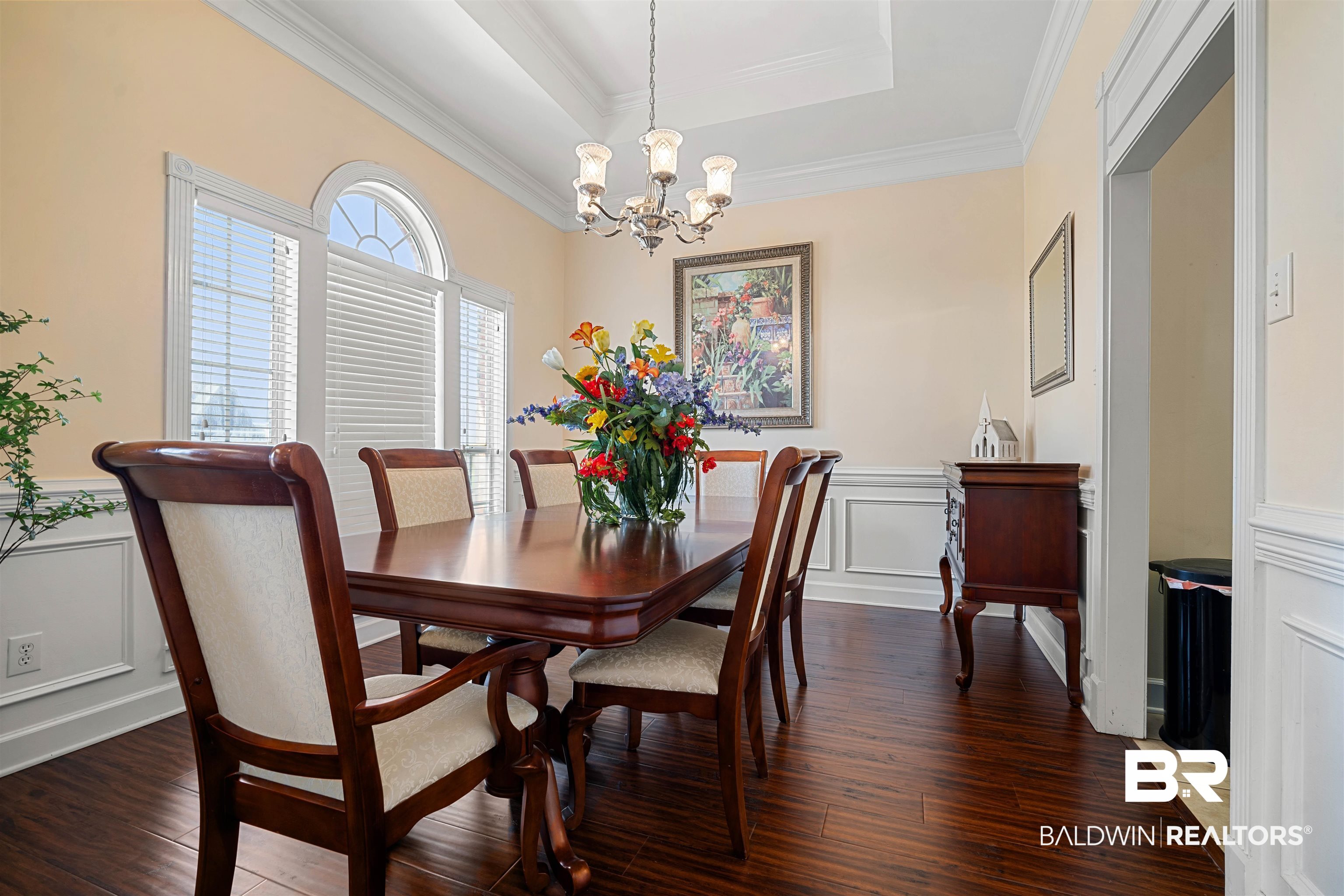 9552 White Castle Road Mobile, AL 36695 - Photo 14 of 31 Dining room with wood finished floors, crown molding, and a notable chandelier