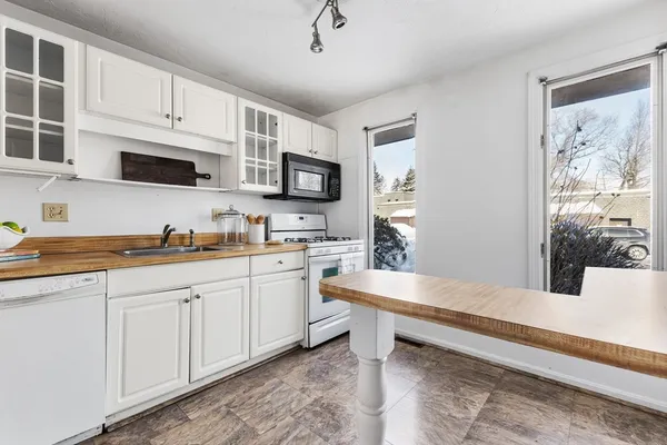a kitchen with sink cabinets and window