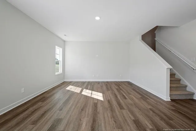 a view of wooden floor and staircase in a room