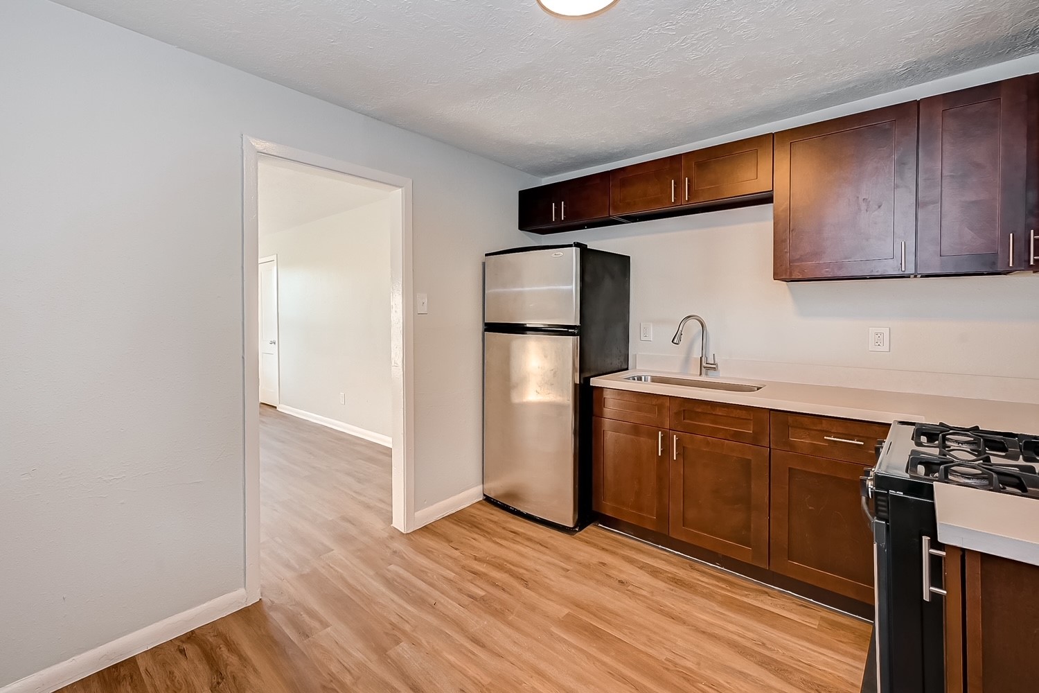 6420 Conley Street, Unit 4 Houston, TX 77021 - Photo 13 of 27 a kitchen with stainless steel appliances a refrigerator and a stove top oven
