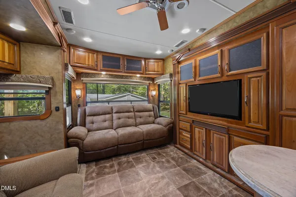 a bedroom with a large bed and a flat tv screen