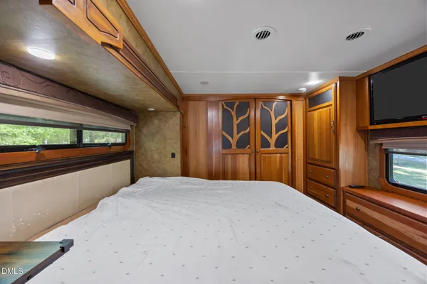 a bedroom with a large bed and a window