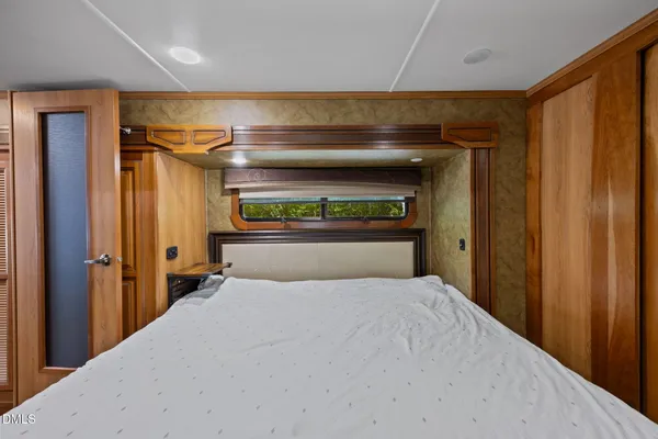 a bedroom with a bed and a television in it