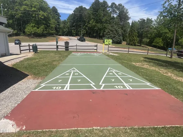 an aerial view of residential houses with outdoor space and trees