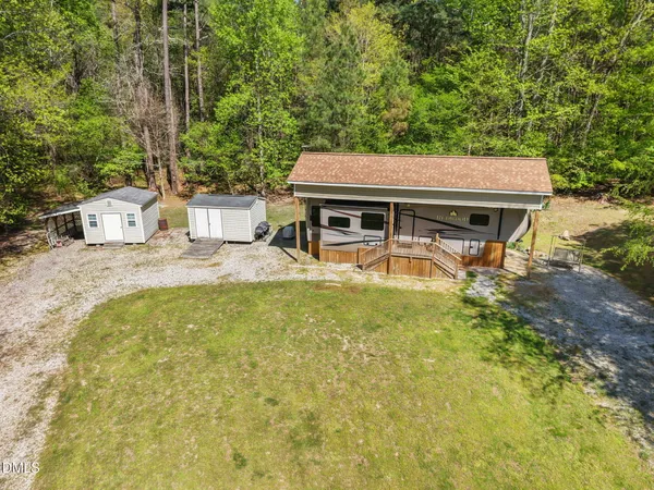 a house view with swimming pool in front of it