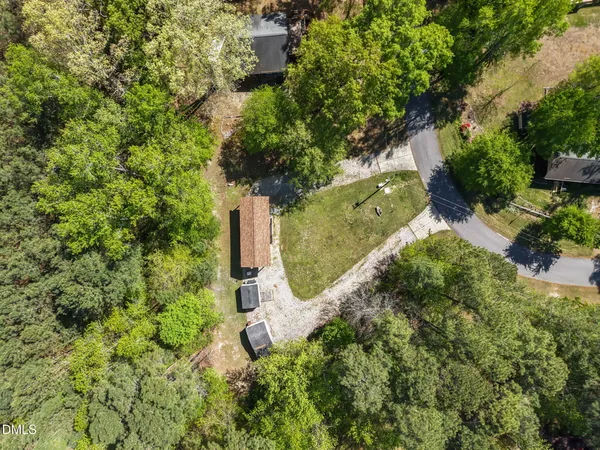 an aerial view of a house with a yard