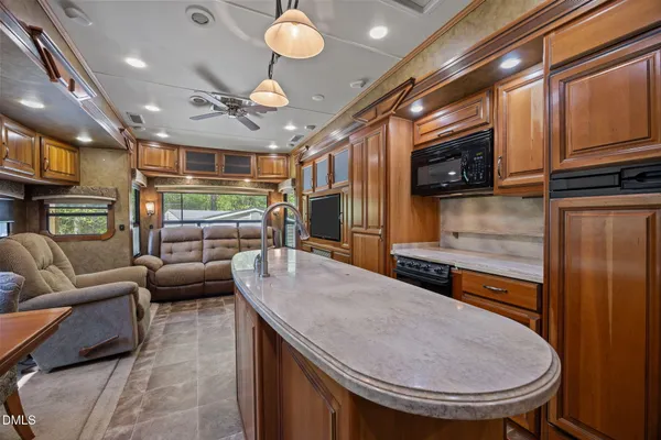 a very nice looking dining room with a large window and chandelier