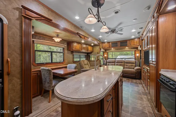 a living room with furniture a flat screen tv and large window
