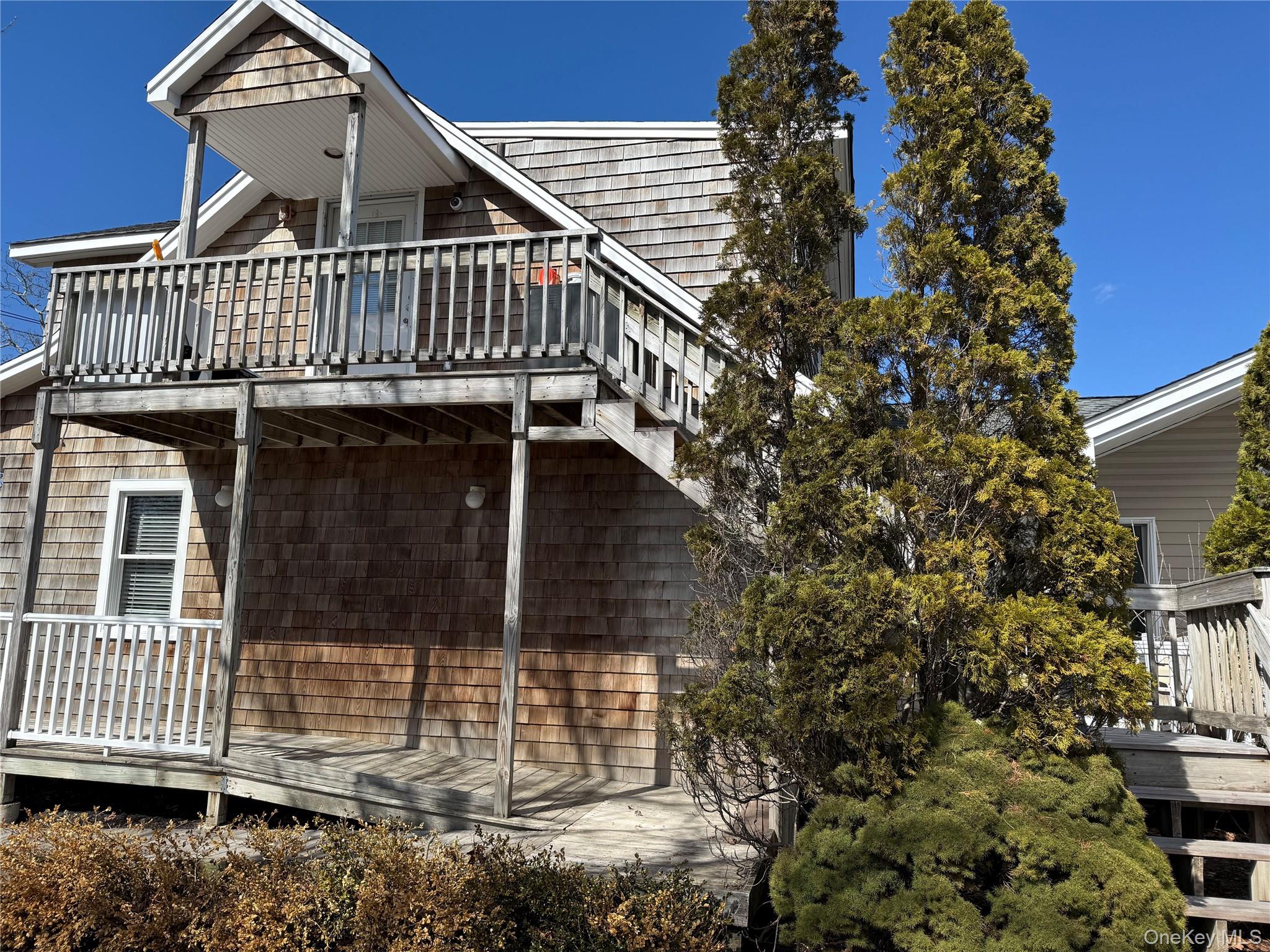 64 Old Riverhead Road Westhampton Beach, NY 11978 - Photo 2 of 9 front view of a house with a small yard