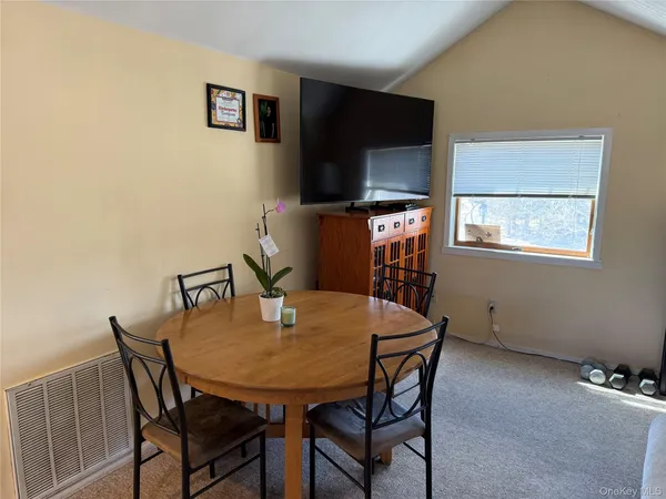 a dining room with furniture and window