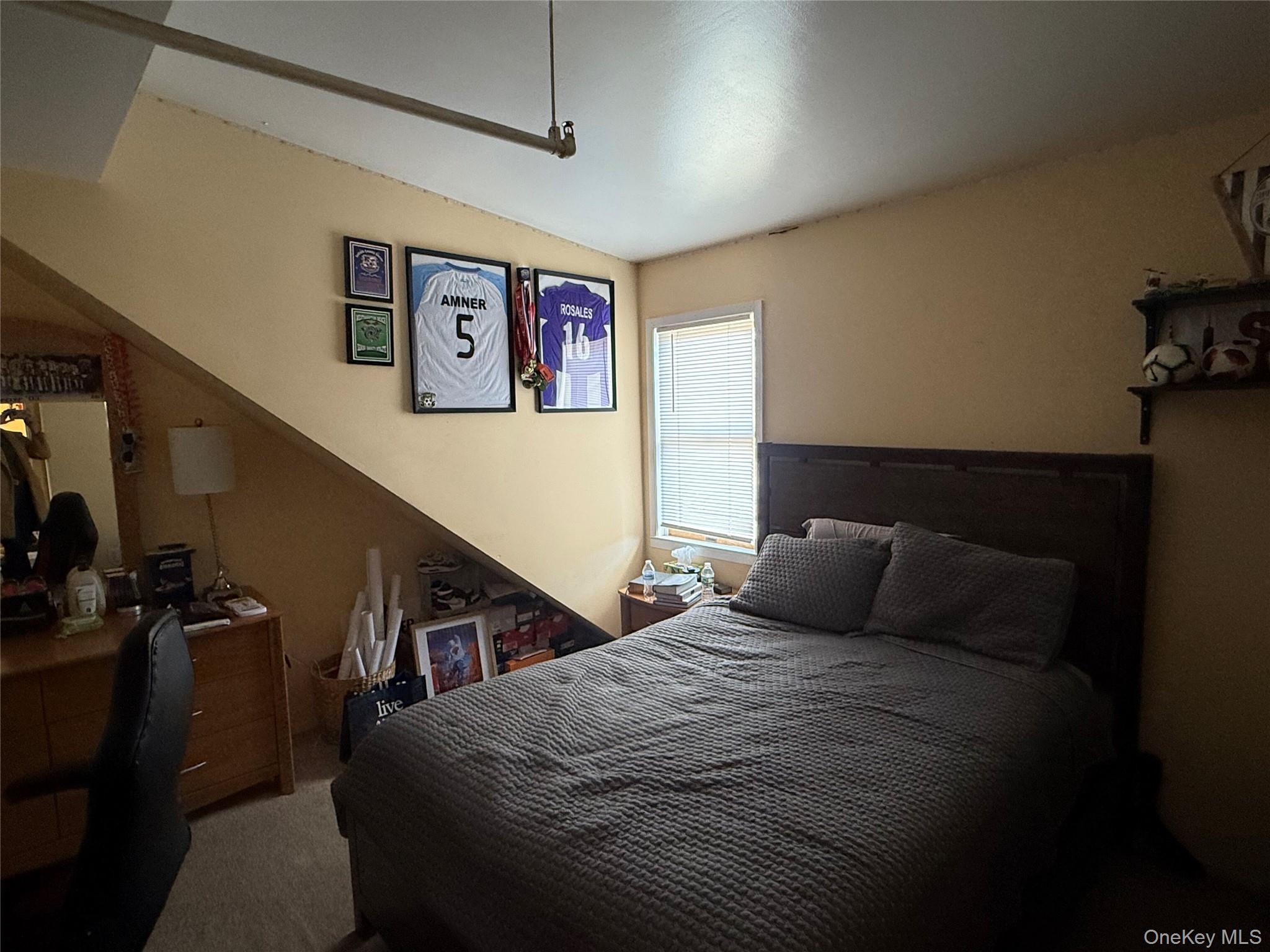 64 Old Riverhead Road Westhampton Beach, NY 11978 - Photo 8 of 9 a bedroom with a bed and wooden floor