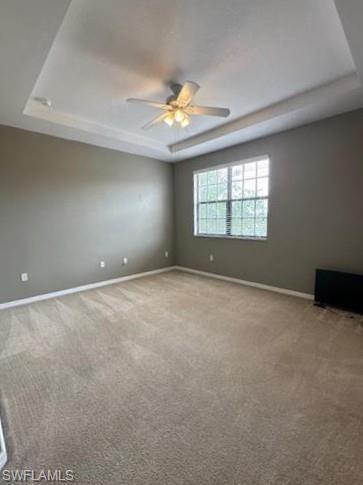 14732 Sutherland Avenue, Unit 332 Naples, FL 34119 - Photo 14 of 33 Carpeted spare room featuring a raised ceiling and a ceiling fan