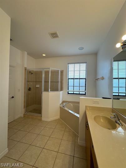 14732 Sutherland Avenue, Unit 332 Naples, FL 34119 - Photo 16 of 33 Bathroom featuring a stall shower, vanity, a bath, and light tile patterned floors