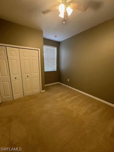 14732 Sutherland Avenue, Unit 332 Naples, FL 34119 - Photo 20 of 33 Unfurnished bedroom with light colored carpet, a ceiling fan, and a closet