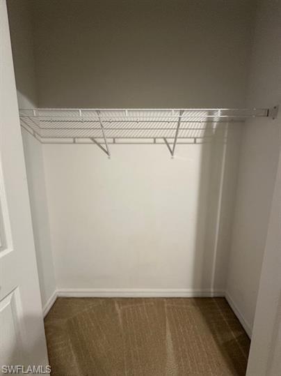 14732 Sutherland Avenue, Unit 332 Naples, FL 34119 - Photo 21 of 33 Walk in closet featuring dark colored carpet