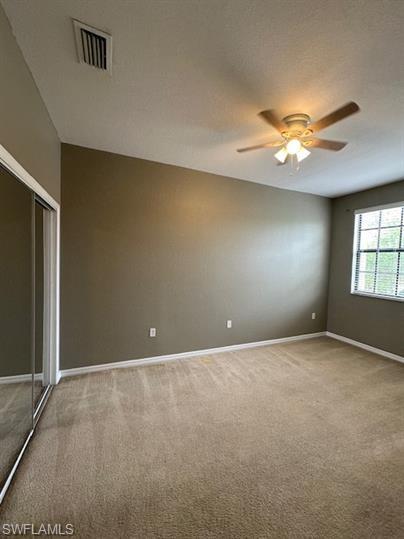 14732 Sutherland Avenue, Unit 332 Naples, FL 34119 - Photo 22 of 33 Spare room with light colored carpet and a ceiling fan