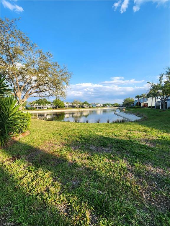 14732 Sutherland Avenue, Unit 332 Naples, FL 34119 - Photo 33 of 35 a view of a lake with houses in the back