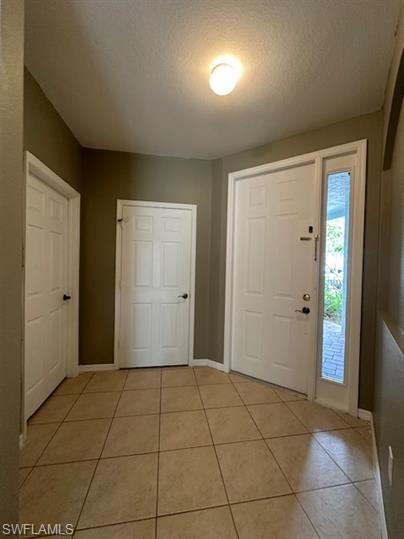 14732 Sutherland Avenue, Unit 332 Naples, FL 34119 - Photo 4 of 33 Foyer featuring light tile patterned floors