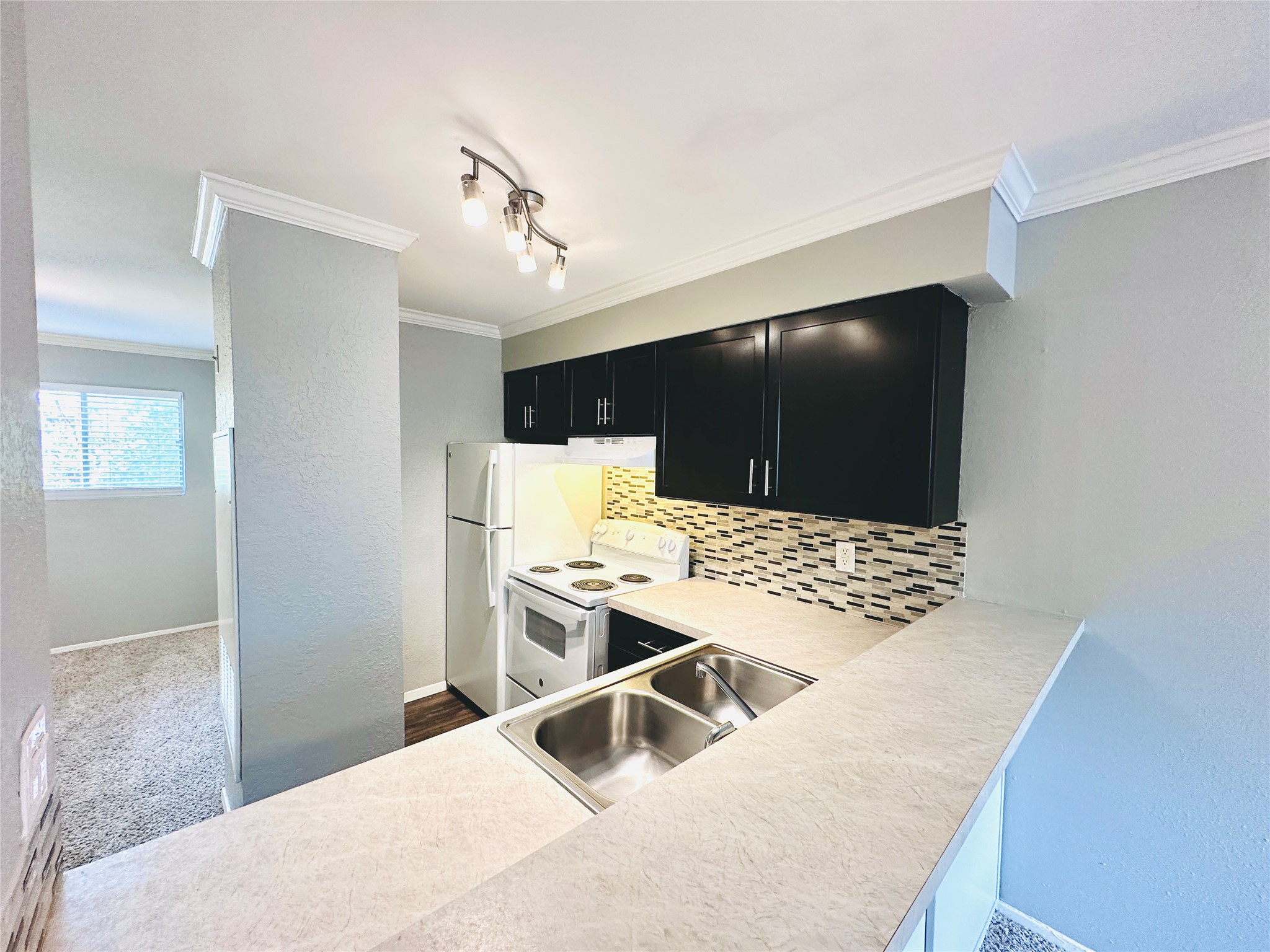 3702 South 2nd Street, Unit 219 Austin, TX 78704 - Photo 1 of 11 a living room with stainless steel appliances kitchen island granite countertop a refrigerator and a sink