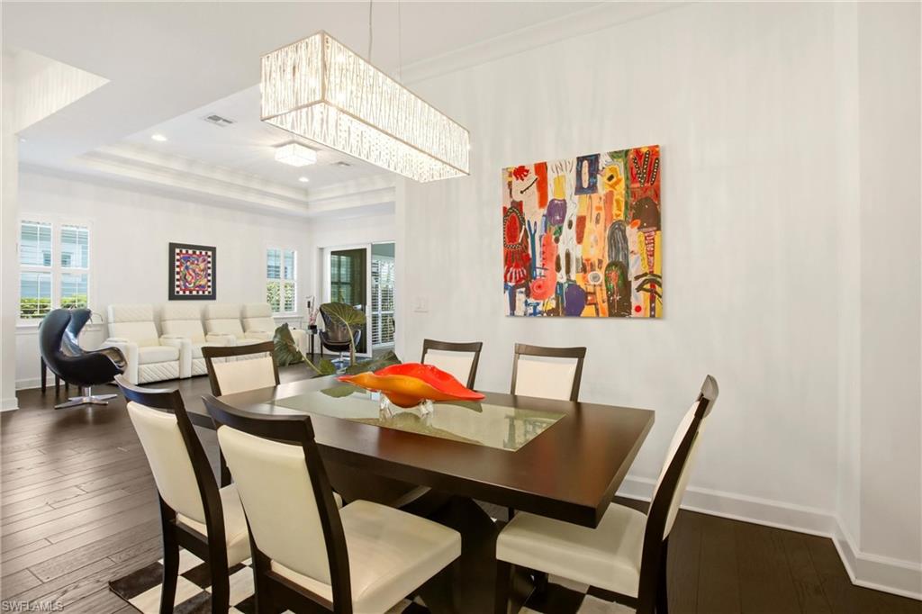 7157 Dominica Drive Naples, FL 34113 - Photo 12 of 39 a view of a dining room with furniture and wooden floor