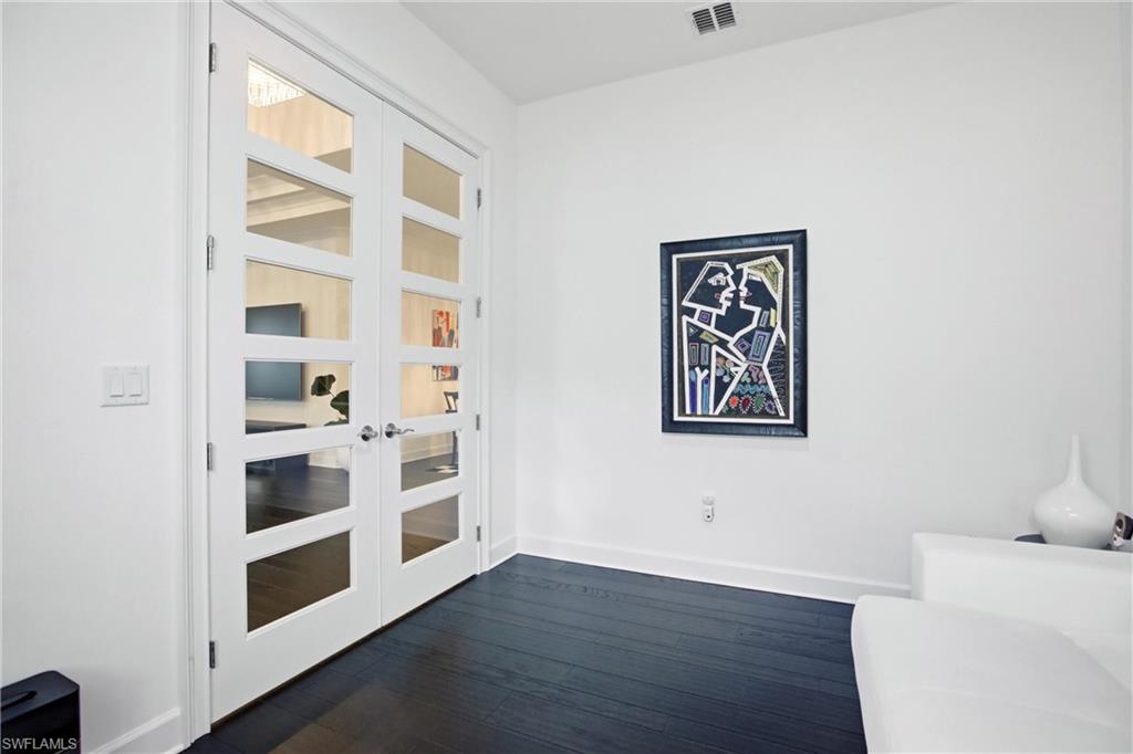 7157 Dominica Drive Naples, FL 34113 - Photo 14 of 39 a view of an empty room with a window and wooden floor
