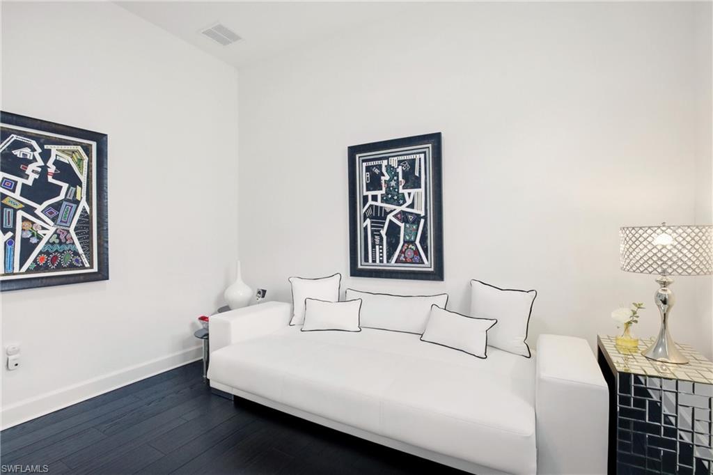 7157 Dominica Drive Naples, FL 34113 - Photo 15 of 39 a bedroom with a bed and a wall painting