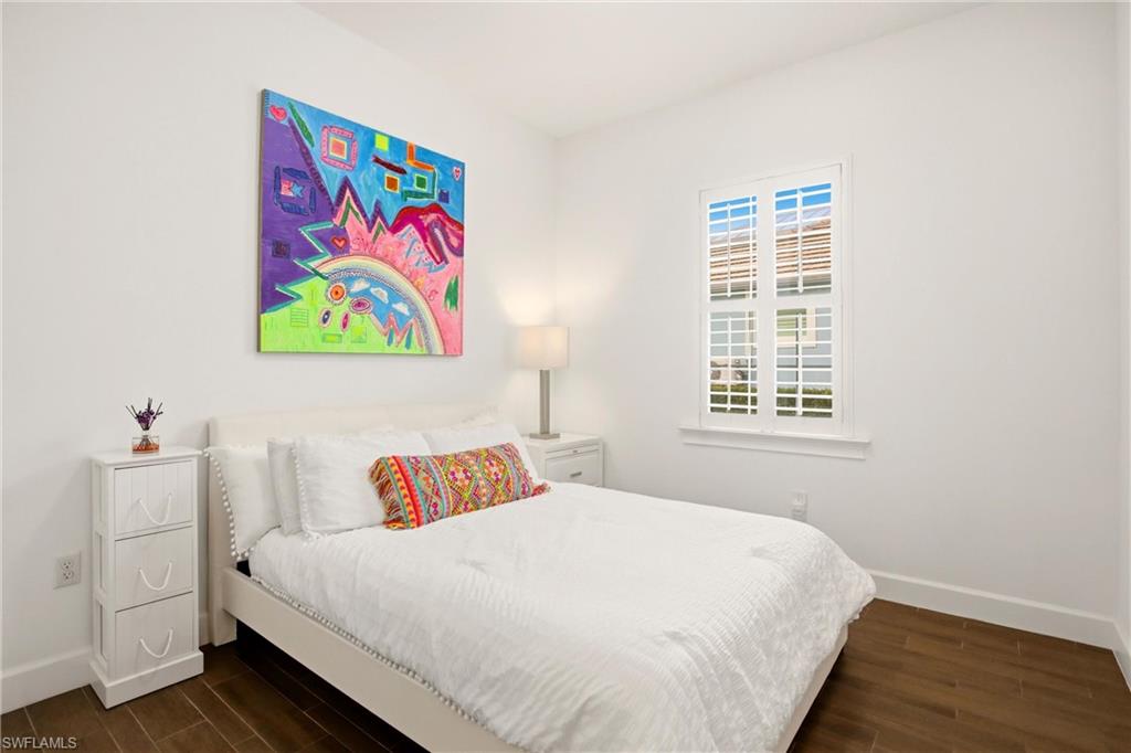 7157 Dominica Drive Naples, FL 34113 - Photo 16 of 39 a bedroom with a bed and a window