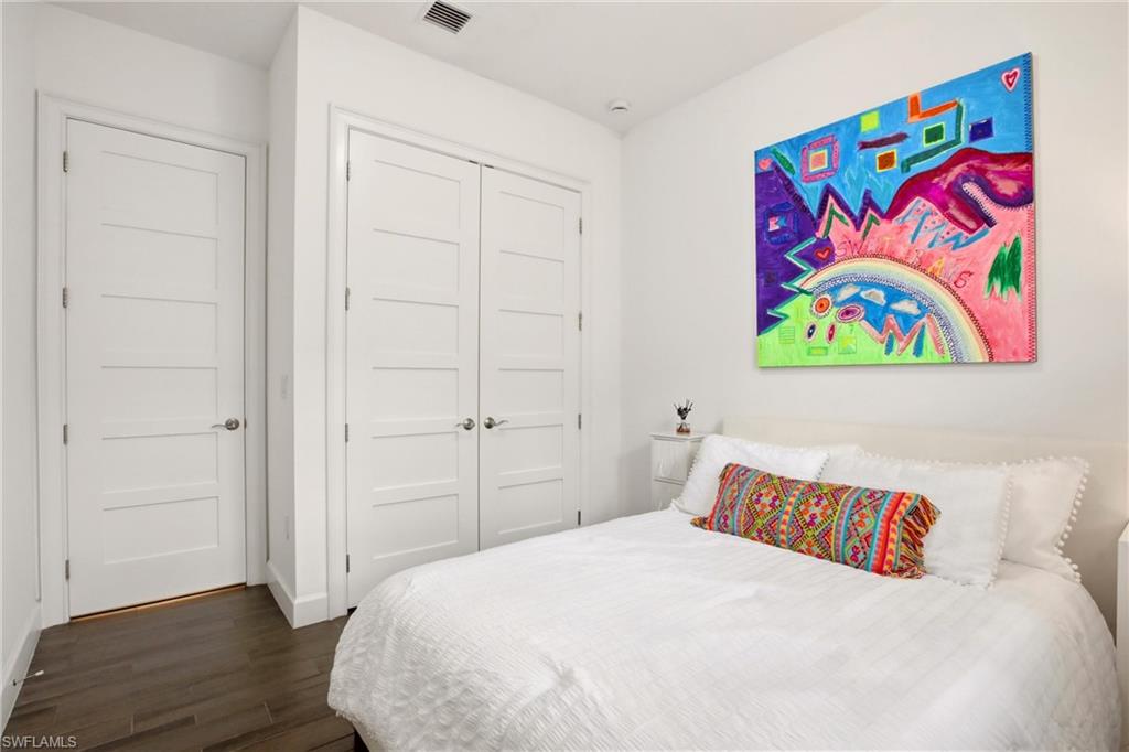 7157 Dominica Drive Naples, FL 34113 - Photo 17 of 39 a bedroom with a bed and painting on the wall