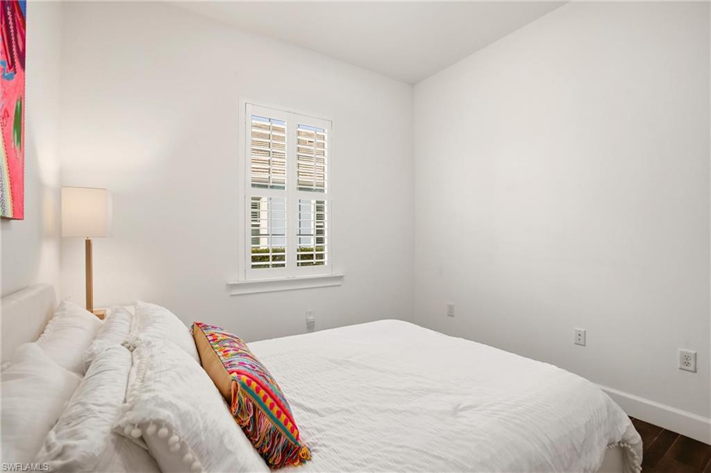7157 Dominica Drive Naples, FL 34113 - Photo 18 of 39 a bedroom with a bed and a window