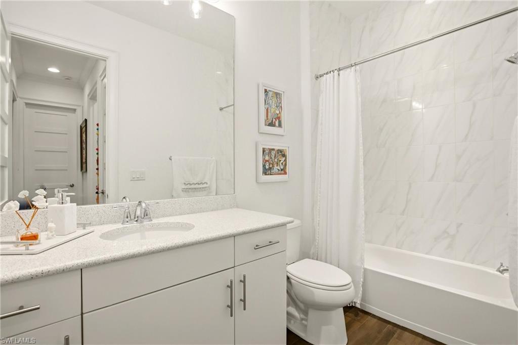 7157 Dominica Drive Naples, FL 34113 - Photo 19 of 39 a bathroom with a sink a toilet and shower